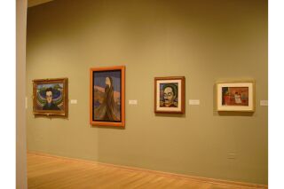 Image of gallery wall with four paintings