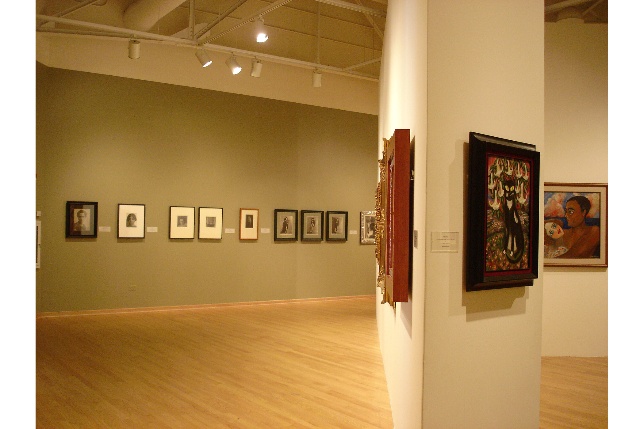 Wide angle of several gallery walls with many pieces of art visible