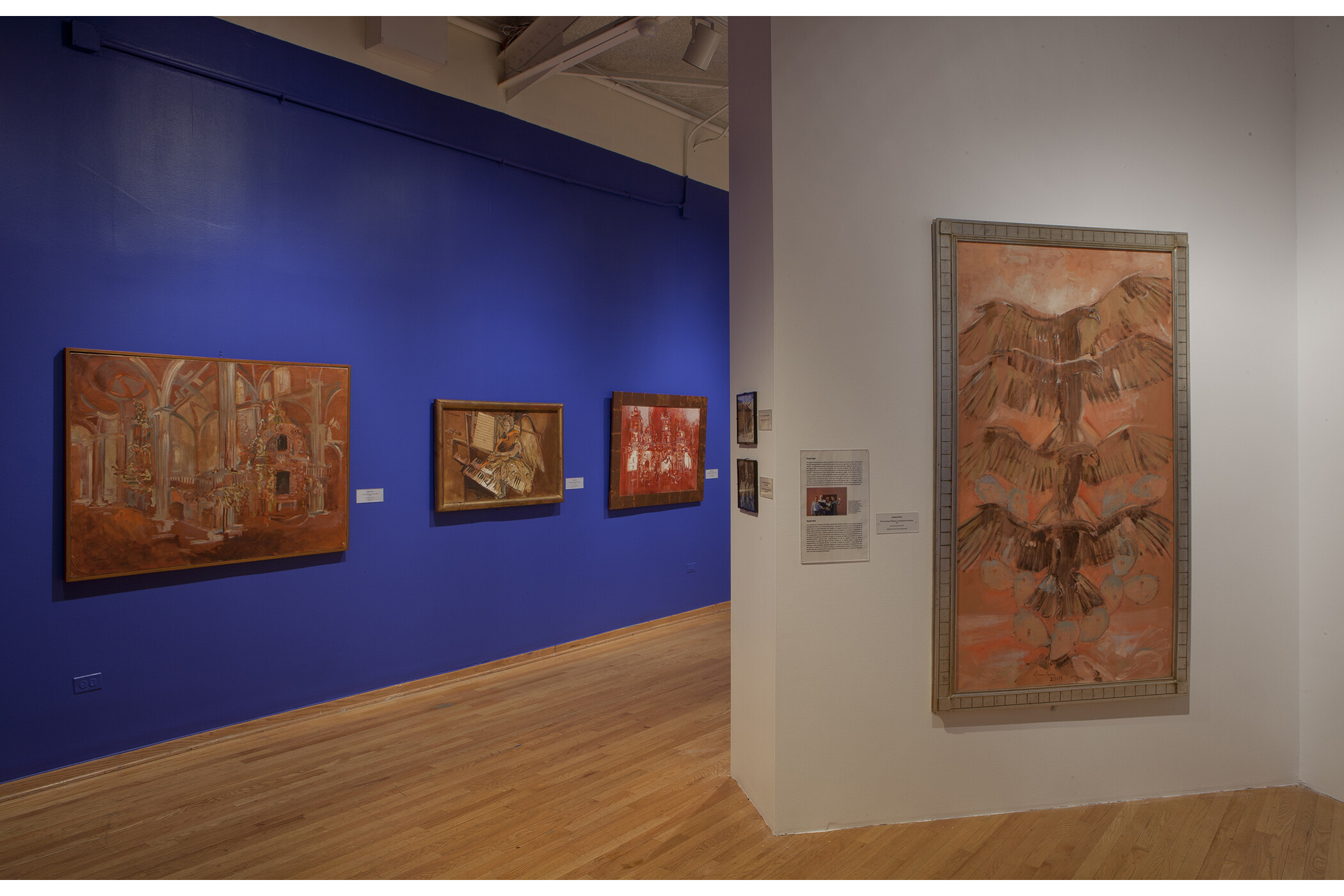 six artworks hang on the walls